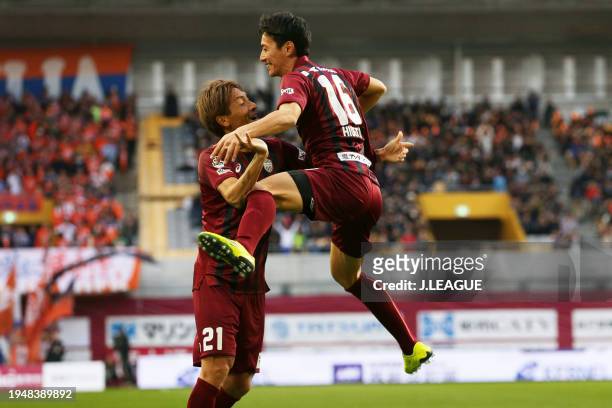 Hideto Takahashi of Vissel Kobe celebrates with teammate Junya Tanaka after scoring the team's second goal during the J.League J1 match between...