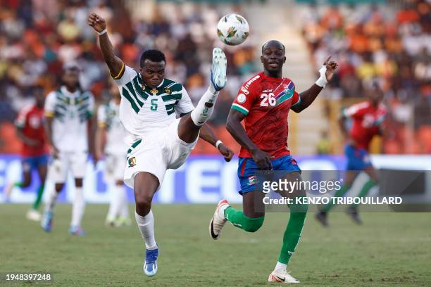 Cameroon's defender Nouhou Tolo fights for the ball with Gambia's forward Ali Sowe during the Africa Cup of Nations 2024 group C football match...