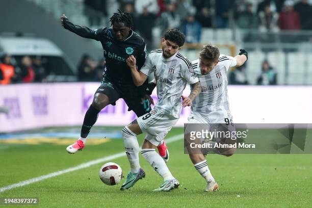 David Akintola of Adana Demirspor is challenged by Semih Kilicsoy and Umut Meras of Besiktas during the Turkish Super League match between Besiktas...