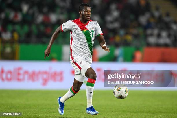 Burkina Faso's forward Dango Ouattara runs with the ball during the Africa Cup of Nations 2024 group D football match between Angola and Burkina Faso...