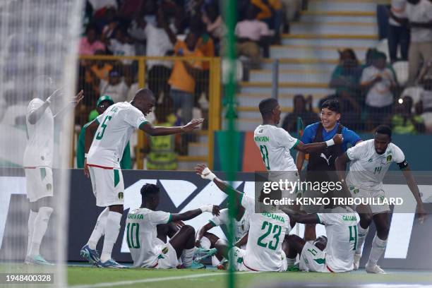 Mauritania players celebrate with Mauritania's defender Dellah Yaly after he scored his team's first goal during the Africa Cup of Nations 2024 group...