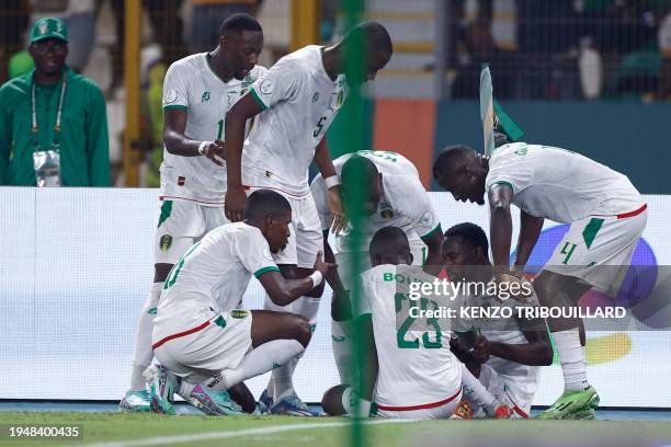 Mauritania players celebrate with Mauritania's defender Dellah Yaly after he scored his team's first goal during the Africa Cup of Nations 2024 group...