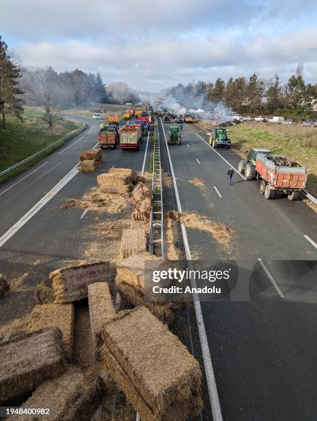An aerial view of road as farmers burns straw as they protest against taxation policy and declining income in Agen, France on January 23, 2024. A...