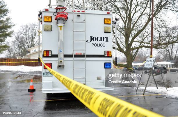 Police officers investigate at the scene where eight people were found shot to death in two homes in Joliet, United States on January 23, 2024....