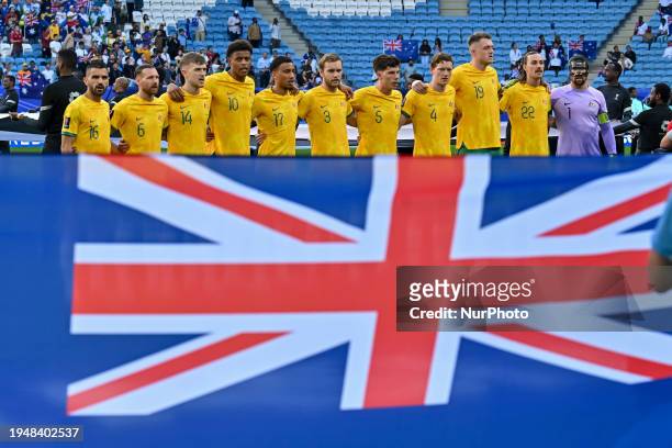 The Australian team players are standing for the national anthem ahead of the AFC Asian Cup 2023 match between Australia and Uzbekistan at Al Janoub...