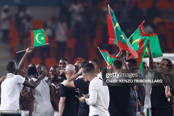 Mauritania's team and staff celebrate after they won the Africa Cup of Nations 2024 group D football match between Mauritania and Algeria at Stade de...