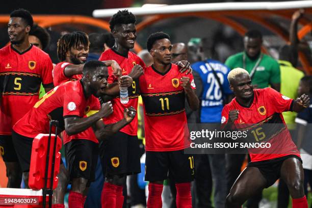 Angola's players celebrate after winning at the end of the Africa Cup of Nations 2024 group D football match between Angola and Burkina Faso at Stade...
