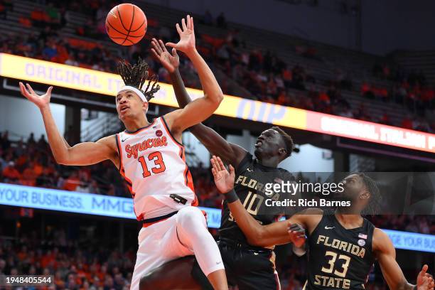 Benny Williams of the Syracuse Orange, Taylor Bol Bowen and Jaylan Gainey of the Florida State Seminoles battle for a loose ball during the first...
