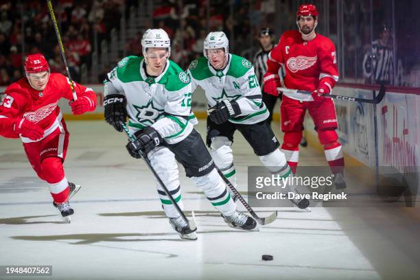 Radek Faksa of the Dallas Stars skates after a loose puck in front of Ryan Suter and Alex DeBrincat of the Detroit Red Wings during the third period...