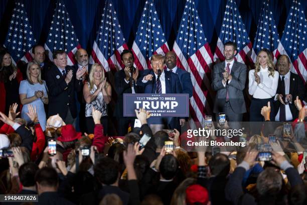 Former US President Donald Trump, center, during a New Hampshire primary election night watch party in Nashua, New Hampshire, US, on Tuesday, Jan....