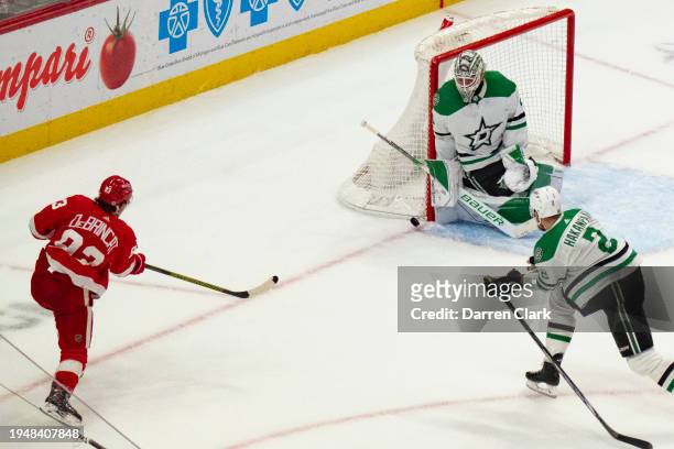 Alex DeBrincat of the Detroit Red Wings has his shot blocked by goalie Jake Oettinger of the Dallas Stars during the third period. Dallas defeats...