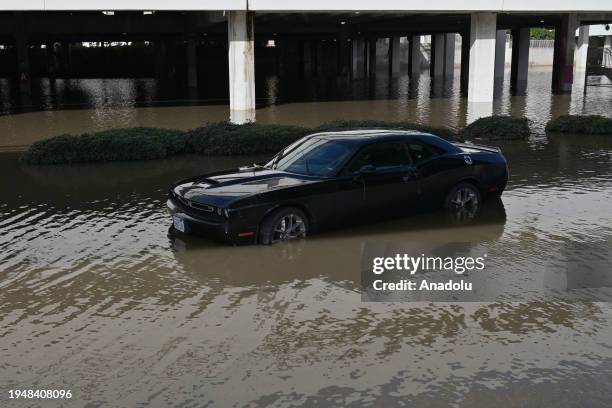 An abandoned car in a flooded area is seen below the Fashion Valley Trolley Station during the aftermath of the storm in San Diego, California. On...