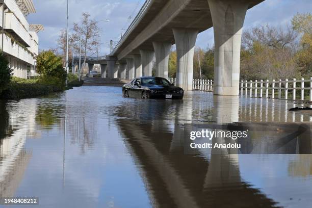 An abandoned car in a flooded area is seen below the Fashion Valley Trolley Station during the aftermath of the storm in San Diego, California. On...