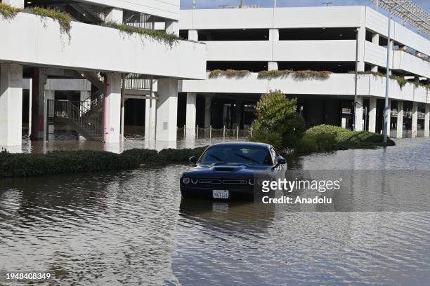 An abandoned car in a flooded area is seen below the Fashion Valley Trolley Station during the aftermath of the storm in San Diego, California. On...