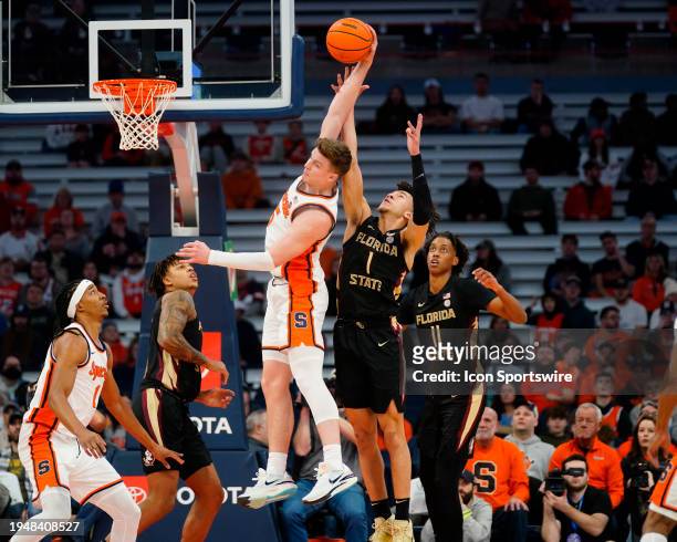 Syracuse Orange Guard Justin Taylor grabs a rebound against Florida State Seminoles Guard Jalen Warley during the first half of the College...