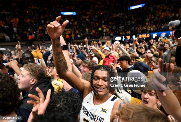 RaeQuan Battle of the West Virginia Mountaineers celebrates with fans after a 91-85 victory agains the Kansas Jayhawks at WVU Coliseum on January 20,...