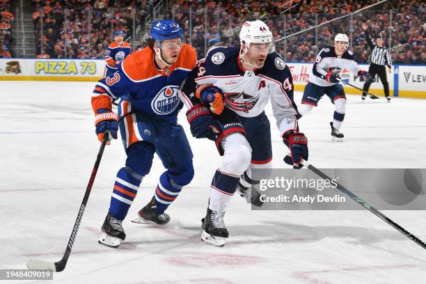 Mattias Janmark of the Edmonton Oilers and Erik Gudbranson of the Columbus Blue Jackets track the play during the game at Rogers Place on January 23...