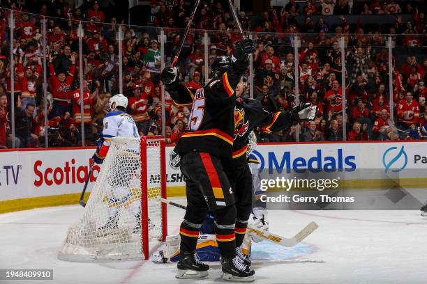 Noah Hanifin of the Calgary Flames celebrates with teammates after a goal against the St Louis Blues at Scotiabank Saddledome on January 23, 2024 in...