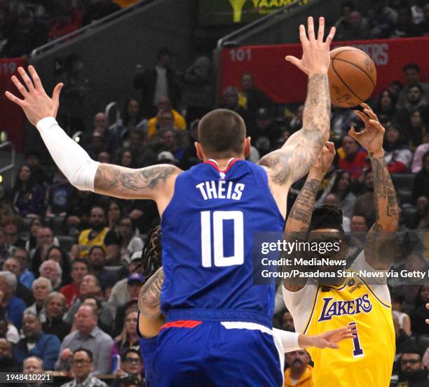 Los Angeles, CA D'Angelo Russell of the Los Angeles Lakers passes over Daniel Theis of the LA Clippers in the first half of a NBA basketball game at...