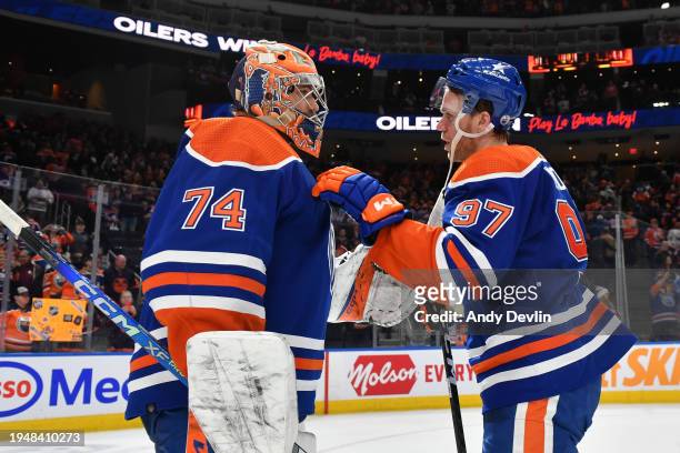 Connor McDavid of the Edmonton Oilers celebrates the win over the Columbus Blue Jackets with goaltender Stuart Skinner while congratulating him on...