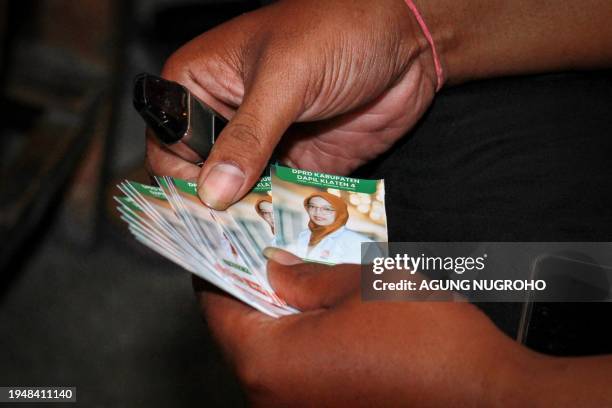 This photo taken on January 18, 2024 shows cards bearing portraits of Lingga Permesti, a legislative candidate for the Islamic Prosperous Justice...
