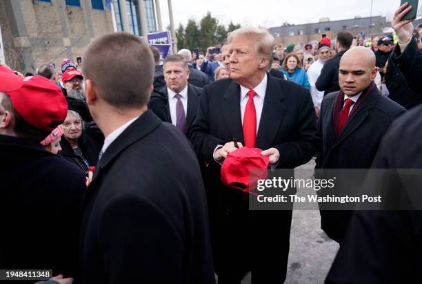 January 23: Former president Donald Trump greets supporters outside a polling location on Tuesday, January 23, 2024 at Londonderry High School in...