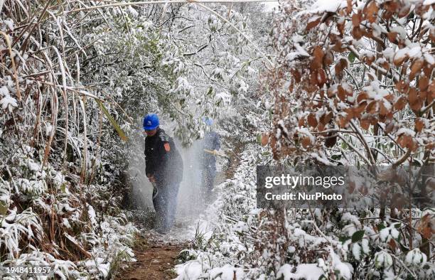 Workers are inspecting power supply lines in the cold mountainous area of Dongling village in Liuzhou, China, on January 23, 2024.