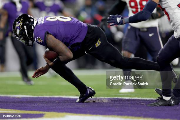 Lamar Jackson of the Baltimore Ravens scores a 15 yard touchdown against the Houston Texans during the third quarter in the AFC Divisional Playoff...