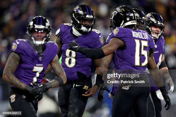 Lamar Jackson of the Baltimore Ravens celebrates with Nelson Agholor after scoring a 15 yard touchdown against the Houston Texans during the third...