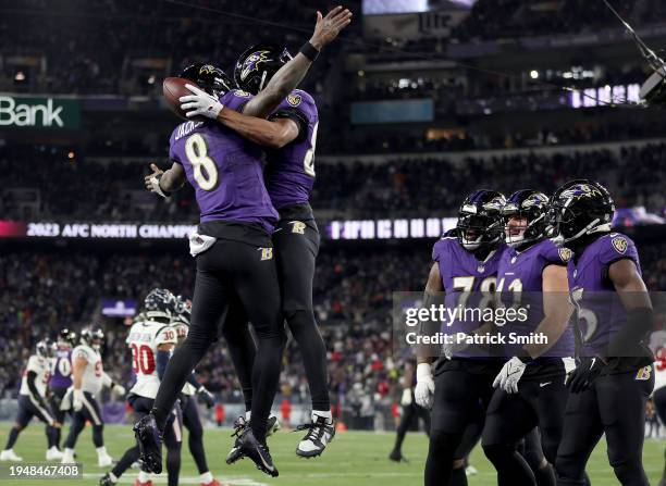 Isaiah Likely of the Baltimore Ravens celebrates with Lamar Jackson after scoring a 15 yard touchdown against the Houston Texans during the fourth...