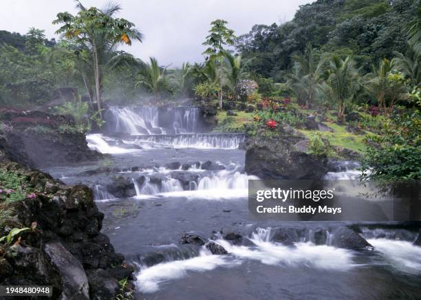 Waterfalls and hot water from the bowels of Arenal Volcano, at Tabacon Hot Springs in the dense rain forest of the Costa Rican highlands, Costa Rica,...