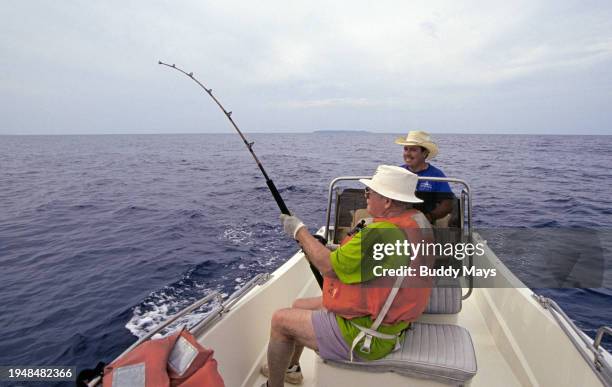 An American fisherman hooks a large sailfish from a skiff on the Pacific Ocean near Drake's Bay and the Osa Peninsula in Western Costa Rica, 2005. .