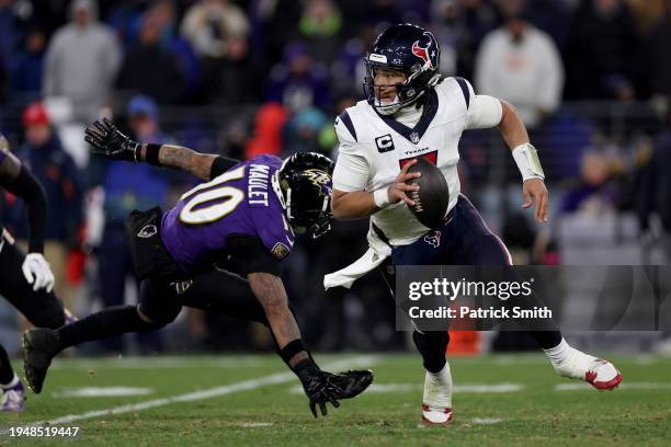 Stroud of the Houston Texans scrambles against Arthur Maulet of the Baltimore Ravens during the fourth quarter in the AFC Divisional Playoff game at...