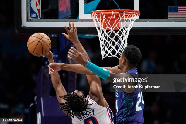 Brandon Miller of the Charlotte Hornets blocks a shot from Tyrese Maxey of the Philadelphia 76ers in the first quarter during their game at Spectrum...