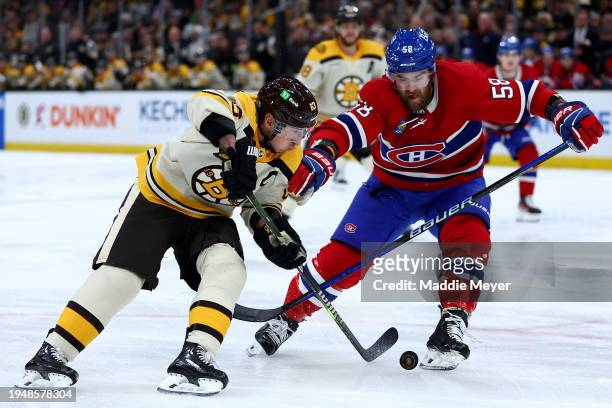 Brad Marchand of the Boston Bruins skates against David Savard of the Montreal Canadiens during the first period at TD Garden on January 20, 2024 in...