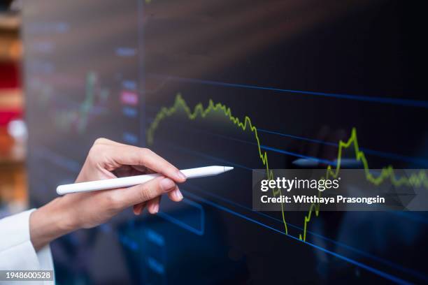 businesswoman use tablet and smart phone for stock market - certificato azionario foto e immagini stock
