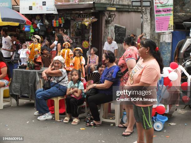 Malabon citizens bring out their images of Santo Niño as they wait for the parade to start. The Feast of Santo Niño, honoring the Holy Child Jesus,...