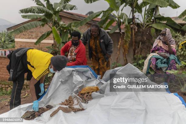 Graphic content / Women try to identify human remains of victims of the 1994 Rwandan Genocide found under the foundations of a house in Ngoma, Rwanda...