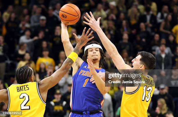 Walter Clayton Jr. #1 of the Florida Gators passes over Tamar Bates and Jesus Carralero Martin of the Missouri Tigers during the 1st half of the game...