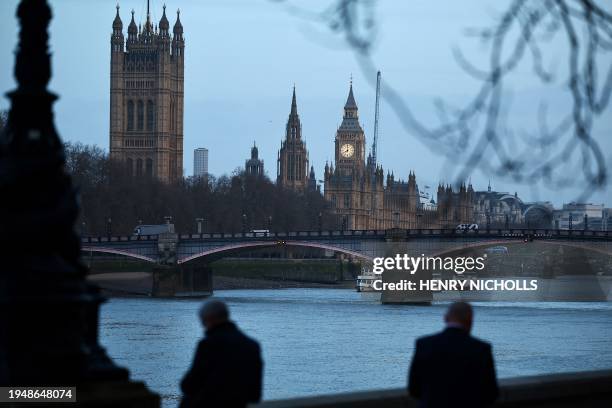 Pedestrians walk along the Southbank by the River Thames, with The Elizabeth Tower, commonly known by the name of the clock's bell "Big Ben", at the...