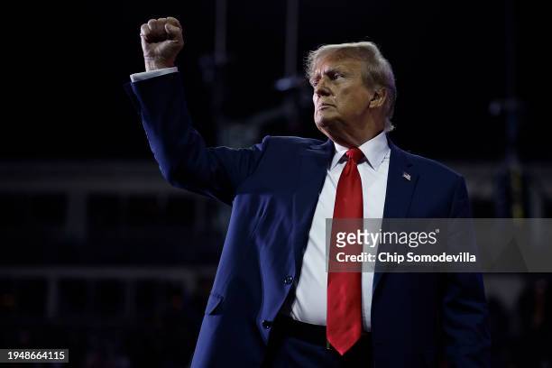Republican presidential candidate and former President Donald Trump pumps his fist as he leaves the stage at the conclusion of a campaign rally at...
