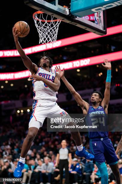 Tyrese Maxey of the Philadelphia 76ers drives to the basket while guarded by Brandon Miller of the Charlotte Hornets in the third quarter during...