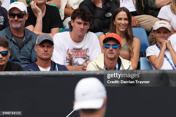 Lleyton Hewitt and Bec Hewitt watch their son Cruz Hewitt of Australia compete against Alexander Razeghi of the United States in their first round...