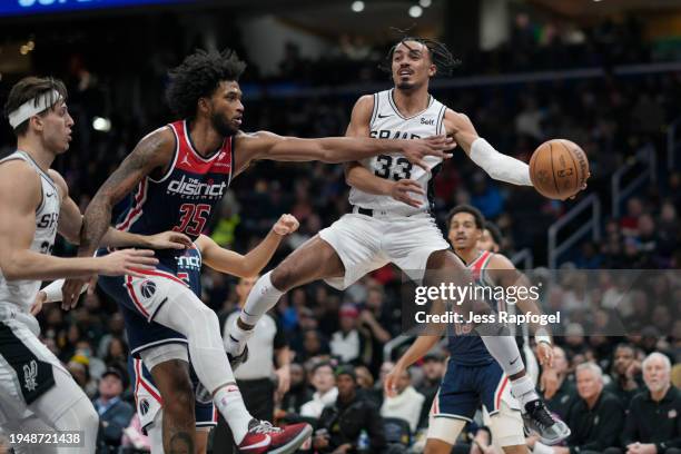 Tre Jones of the San Antonio Spurs passes the ball as Marvin Bagley III of the Washington Wizards defends during the second half at Capital One Arena...