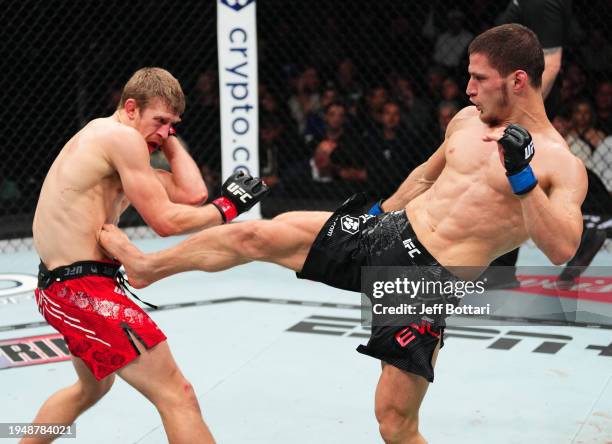 Movsar Evloev of Russia kicks Arnold Allen of England in a featherweight bout during the UFC 297 event at Scotiabank Arena on January 20, 2024 in...