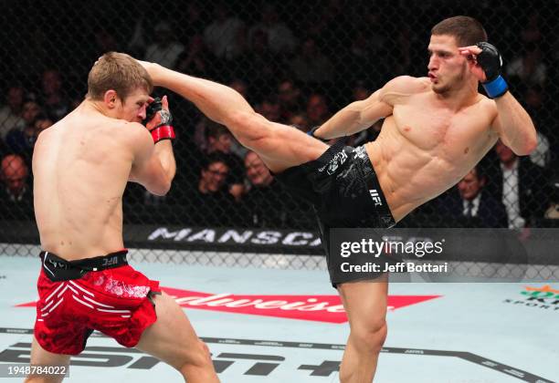 Movsar Evloev of Russia kicks Arnold Allen of England in a featherweight bout during the UFC 297 event at Scotiabank Arena on January 20, 2024 in...