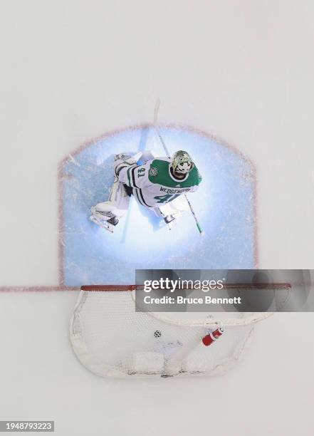 Spotlight hits Scott Wedgewood of the Dallas Stars after he looses his shut out bid against the New Jersey Devils at Prudential Center on January 20,...