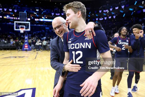 Head coach Dan Hurley and Cam Spencer of the Connecticut Huskies react after defeating the Villanova Wildcats at the Wells Fargo Center on January...