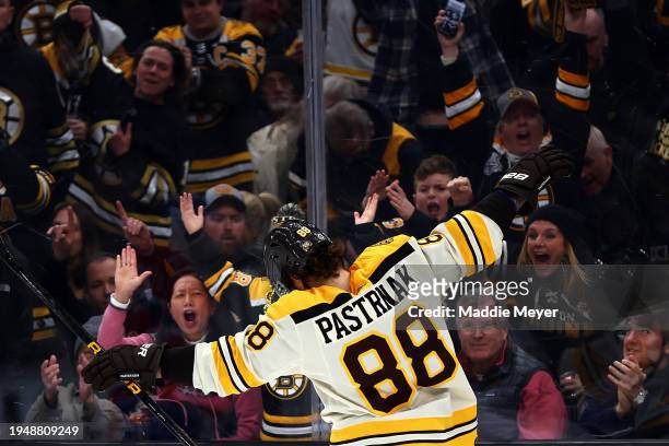 David Pastrnak of the Boston Bruins celebrates with fans after scoring a goal against the Montreal Canadiens during the third period at TD Garden on...