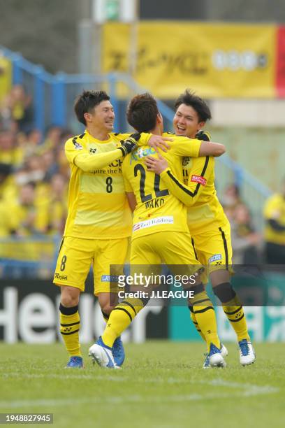 Yusuke Kobayashi of Kashiwa Reysol celebrates with teammates Naoki Wako and Kosuke Taketomi after scoring the team's first goal during the J.League...